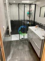 a bathroom with a shower and a sink at appartement au rez de jardin in Morangis