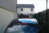 a car parked in front of a house at appartement au rez de jardin in Morangis