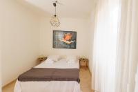 A bed or beds in a room at Kallopsia - Glifada Beach Menigos Resort by New Era