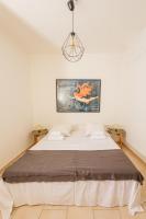 A bed or beds in a room at Kallopsia - Glifada Beach Menigos Resort by New Era
