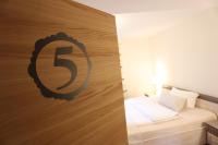 a bedroom with a wooden wall with the letter s on it at Pension Alte Scheune in Melsungen