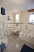 a bathroom with a tub and a toilet and a sink at Pension Alte Scheune in Melsungen