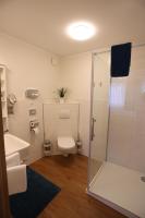 a bathroom with a shower and a toilet and a sink at Pension Alte Scheune in Melsungen