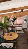 a wooden patio with a wooden table and chairs at Mobil home 6 personnes Forêt des landes in Mimizan