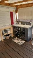 a kitchen with a sink and a counter top at Mobil home 6 personnes Forêt des landes in Mimizan