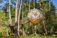 a large object is hanging in the trees at Dihan Evasion in Ploemel