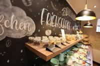 a bakery with a counter with jars of food at Pension Alte Scheune in Melsungen