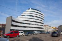 a large building with cars parked in front of it at Apartmány Viviena in Brno