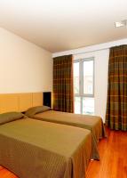 A bed or beds in a room at Victoria Terme Hotel