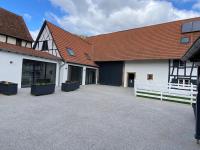 a large white building with a red roof at A la ferme in Kurtzenhouse