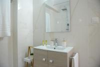 a white bathroom with a sink and a mirror at Casa Raymo in Kanálion