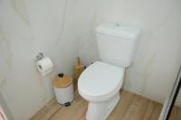 a bathroom with a toilet and a roll of toilet paper at Casa Raymo in Kanálion