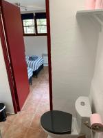 a bathroom with a toilet and a room with a bed at Maison Castellane Chambre d&#39;Hotes B&amp;B in Castellane