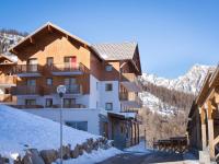 a building in the mountains with snow on the ground at Appartement Puy-Saint-Vincent, 2 pièces, 4 personnes - FR-1-504-340 in Puy-Saint-Vincent