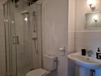 a bathroom with a shower and a toilet and a sink at L &#39;Aupinouse Chambre double Pivoine avec salle d&#39;eau privative in La Suze-sur-Sarthe