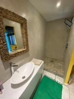 a bathroom with a white sink and a mirror at Casa Costa in Barbaggio