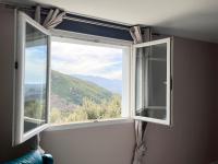 a window with a view of a mountain at Casa Costa in Barbaggio