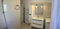 a white bathroom with a sink and a shower at Les oliviers in Juvignac
