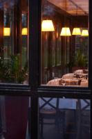 a dining room with a table with chairs and lights at Schloss Wissen in Weeze