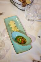 a plate of food on a table with wine glasses at Schloss Wissen in Weeze