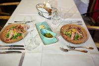 a white table with two dishes of food on it at Schloss Wissen in Weeze