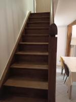 a set of stairs in a room with a table at Gîte Linglet in Fumay