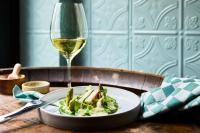 a plate of food and a glass of white wine at Kasteel Kerckebosch in Zeist