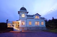 a large white house with a clock tower on it at PortoBay Serra Golf in Santo António da Serra