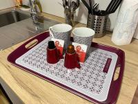 a red and white tray on a kitchen counter with hot dogs at Le Briais in Melun