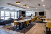 a dining room with tables and yellow chairs at Microtel Inn & Suites by Wyndham Kanata Ottawa West in Kanata