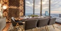 a dining room with a table and chairs and a large window at Mint House Dallas - Downtown in Dallas