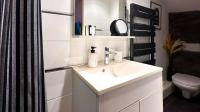 a white bathroom with a sink and a toilet at Studio Casa Aelys - Quartier des Arènes - Béziers in Béziers
