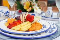 a plate of fruit and vegetables on a table at Alfahar Hotel in Carmen de Viboral