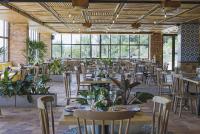 a dining room with tables and chairs and windows at Alfahar Hotel in Carmen de Viboral
