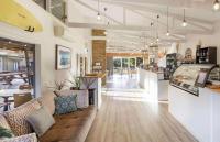 a lobby of a store with a couch and a bar at The Nature Resort Villas in Cowes