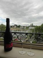 a bottle of wine and two wine glasses on a balcony at QUAI 2 in Saumur