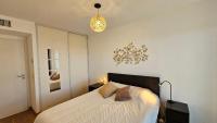 a bedroom with a bed and a pendant light at Arbre Blanc, une folie montpelliéraine in Montpellier