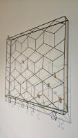 a metal rack with glass shelves on a wall at Arbre Blanc, une folie montpelliéraine in Montpellier