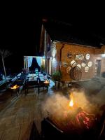 an outdoor patio with a fire pit at night at Villa Breza Brezovice in Brezovica