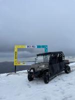 a jeep parked in the snow next to a sign at Villa Breza Brezovice in Brezovica