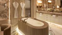 a bathroom with a bath tub and a sink at Jumeirah Mina Al Salam Dubai in Dubai