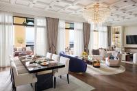 a living room with a chandelier and a table and chairs at Jumeirah Mina Al Salam Dubai in Dubai
