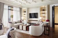 a living room with white furniture and a flat screen tv at Jumeirah Mina Al Salam Dubai in Dubai