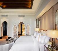 a bedroom with a white bed and a couch at Jumeirah Mina Al Salam Dubai in Dubai