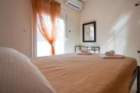 Posteľ alebo postele v izbe v ubytovaní Kyriakos Apartment