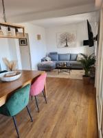 a living room with a table and a couch at Appartement de charme proche de la mer in Hyères