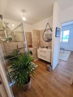 a large bathroom with a sink and a mirror at Appartement de charme proche de la mer in Hyères