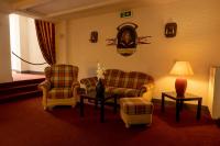 a living room with two chairs and a table with a lamp at Hotel Anker in Saalfeld