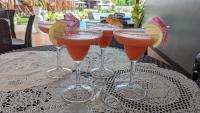a group of four drinks in wine glasses on a table at Bakawan Hideaway Resort and Restaurant in Tomas Oppus