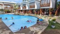a group of children in a swimming pool at a resort at Bakawan Hideaway Resort and Restaurant in Tomas Oppus